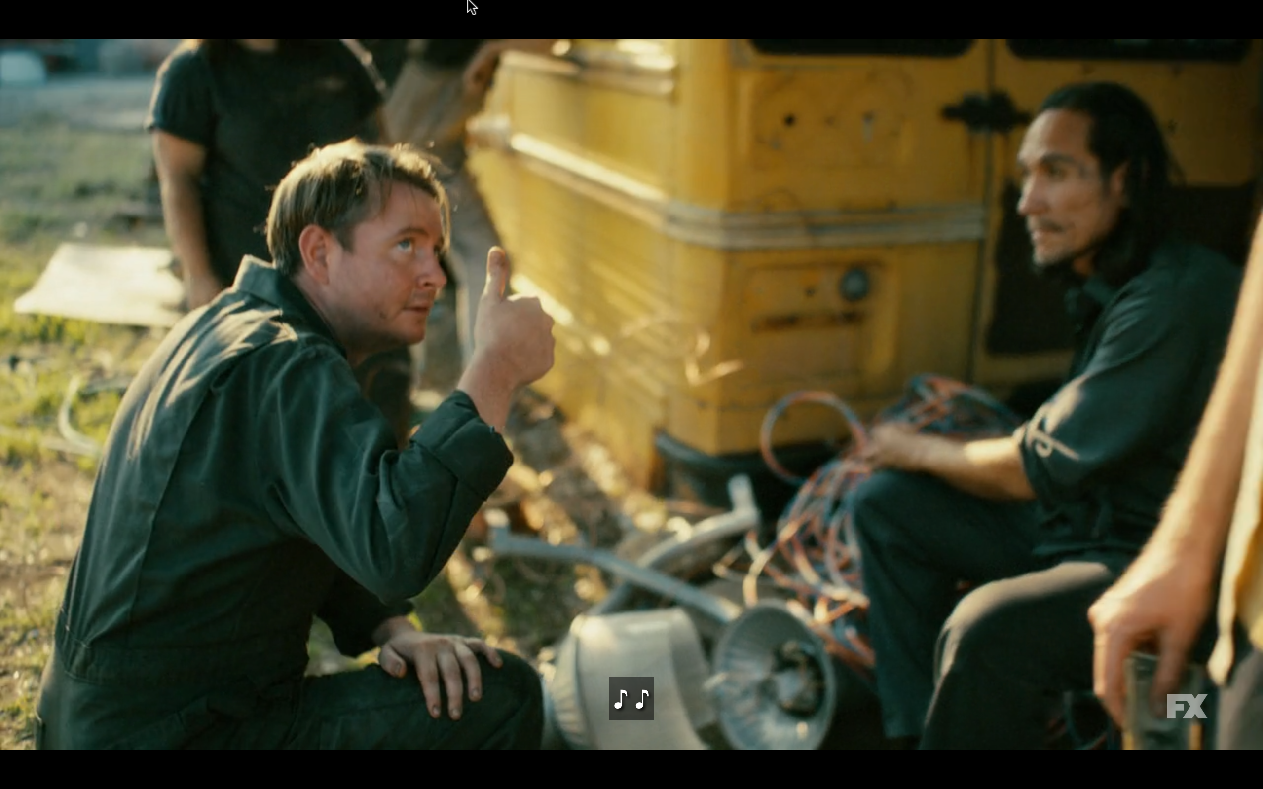 Screen capture with John Fullbright with dirty face, wearing coveralls, holding one thumb up
